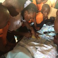 Doreen guiding learners to ensure they produce quality knitted reusable sanitary pads-2